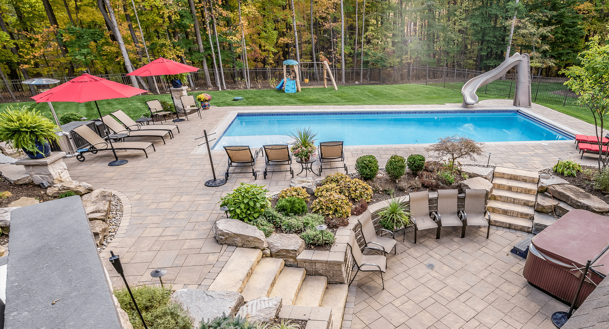 a couple of lawn chairs sitting on top of a bench in a garden